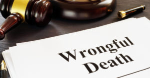 Wrongful Death report with a gavel and pencil