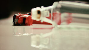 overturned truck behind an empty liquor bottle