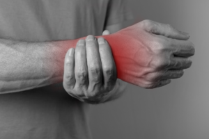 man suffering from a soft-tissue injury on his wrist